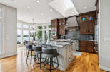 Experience luxury living in this stunning kitchen featuring a large island with a granite countertop, perfect for entertaining.