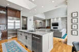 Experience luxury living in this stunning open-concept home, featuring a gourmet kitchen with a large island, sleek stainless steel appliances, and ample cabinet space.