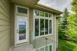 Experience breathtaking lake views from this stunning property, featuring a modern exterior with elegant siding and large windows.