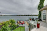 Experience luxurious waterfront living with this stunning property featuring a spacious deck overlooking a serene lake.