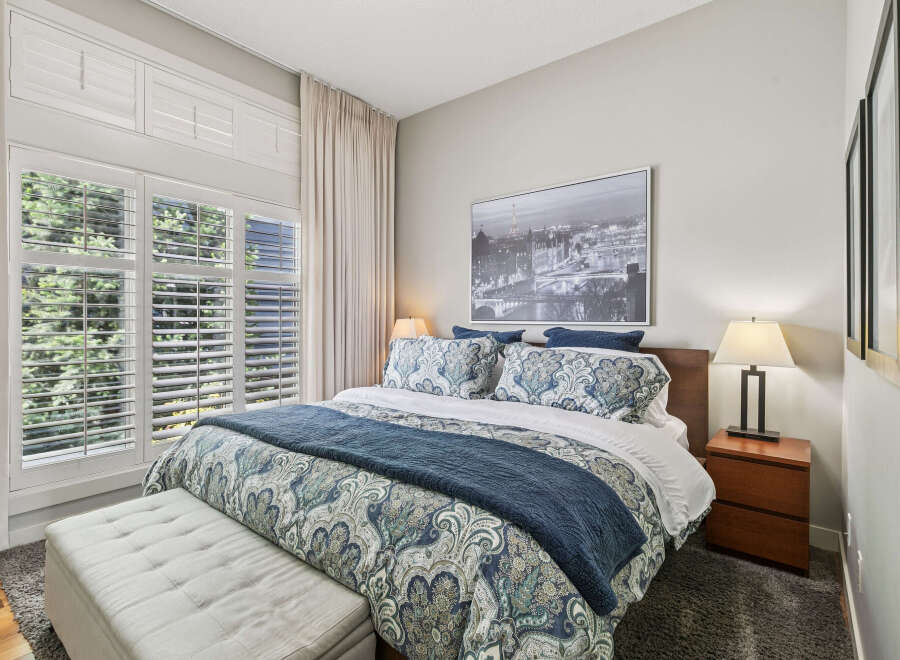 Experience ultimate comfort in this beautifully appointed bedroom, featuring a luxurious king-sized bed adorned with elegant paisley bedding and a plush navy throw.