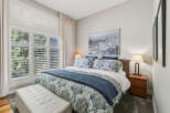 Experience ultimate comfort in this beautifully appointed bedroom, featuring a luxurious king-sized bed adorned with elegant paisley bedding and a plush navy throw.