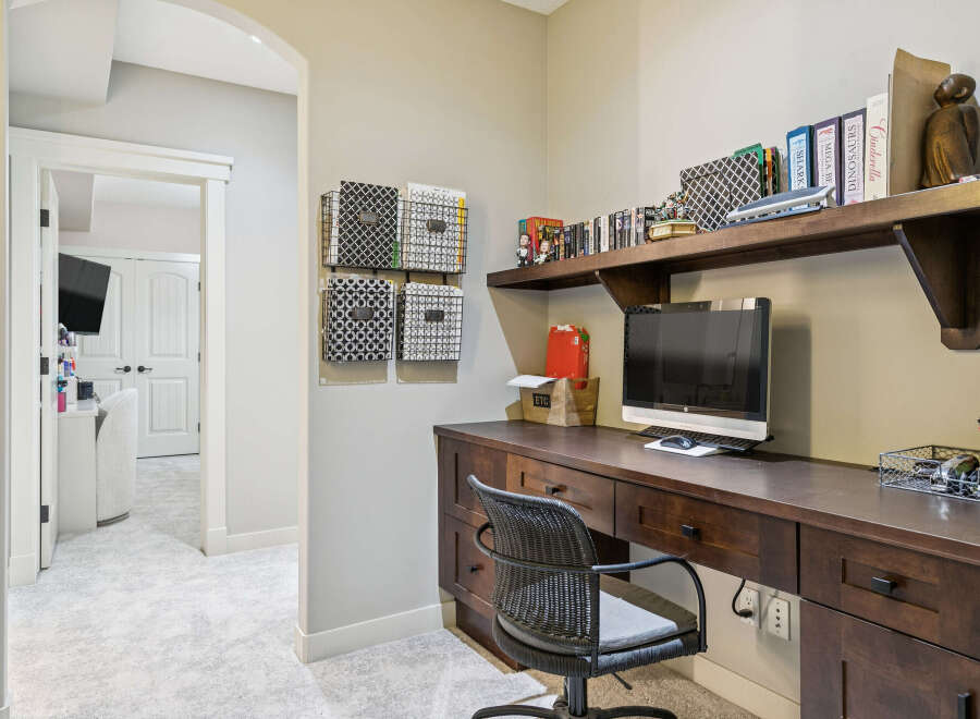 This home office features a spacious wooden desk with ample storage, perfect for organizing your work essentials.