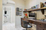 This home office features a spacious wooden desk with ample storage, perfect for organizing your work essentials.