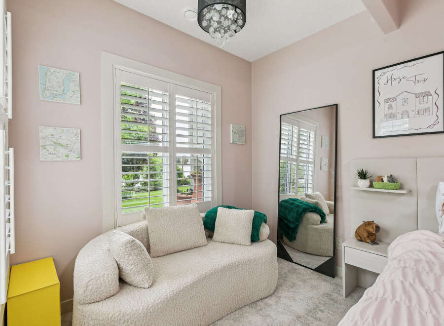 Discover this charming bedroom featuring a plush, textured chaise lounge perfect for relaxation.