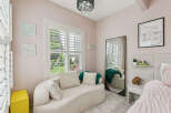 Discover this charming bedroom featuring a plush, textured chaise lounge perfect for relaxation.