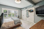 This bedroom features a comfortable bed with a chunky knit throw, perfect for relaxation.