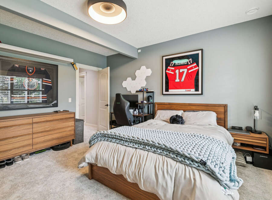 This modern bedroom features a comfortable king-size bed with a plush knit throw, perfect for relaxation.