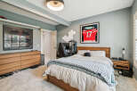 This modern bedroom features a comfortable king-size bed with a plush knit throw, perfect for relaxation.