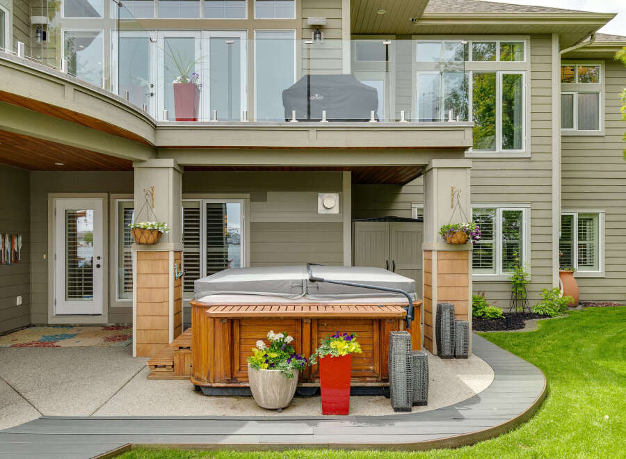 Experience ultimate relaxation in this stunning backyard oasis, featuring a luxurious wooden hot tub perfect for unwinding.