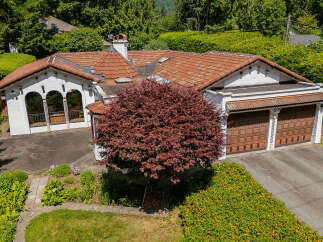 Discover this charming home featuring a distinctive red tile roof and a beautiful Japanese maple tree in the front yard.