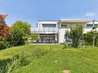 Enjoy outdoor living with this property's spacious backyard, featuring a wooden deck perfect for entertaining.