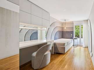 Discover this modern bedroom featuring a stylish upholstered headboard with a unique curved design.