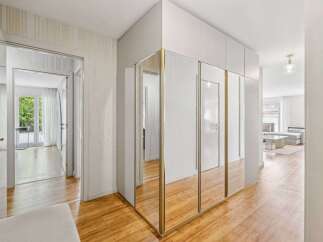 Step into this elegant hallway featuring a mirrored wardrobe that amplifies the sense of space.
