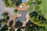 Discover this stunning property from an aerial perspective, showcasing a spacious home with an expansive deck perfect for outdoor entertaining.