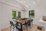 Experience modern dining in this beautifully appointed space, featuring a live-edge wood table and sleek metal chairs.