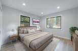 Experience serene living in this beautifully appointed bedroom, featuring a plush tufted headboard and a cozy duvet.