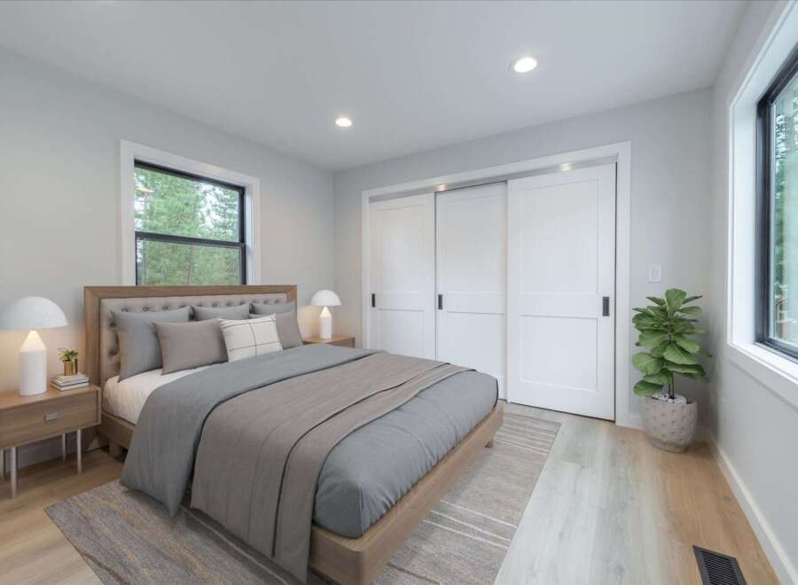 Experience serene living in this beautifully appointed bedroom, featuring a plush upholstered headboard and comfortable bedding.