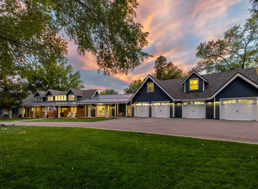 This stunning property boasts a spacious multi-car garage with elegant white doors, perfect for car enthusiasts or ample storage.