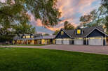 This stunning property boasts a spacious multi-car garage with elegant white doors, perfect for car enthusiasts or ample storage.