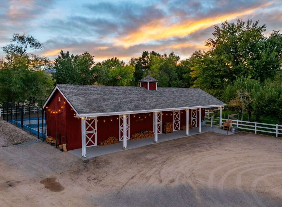 Experience rustic charm with this stunning red barn, perfect for equestrian enthusiasts or as a versatile event space.