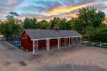 Experience rustic charm with this stunning red barn, perfect for equestrian enthusiasts or as a versatile event space.