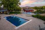 Experience luxury outdoor living with this stunning property featuring a rectangular swimming pool and a full-size basketball court.