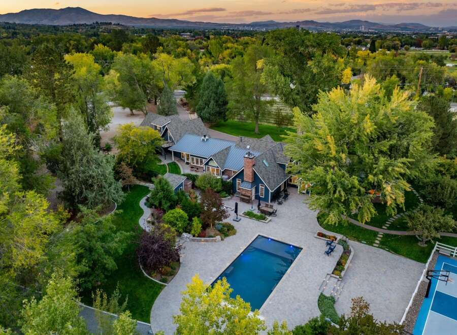 Experience luxury living in this stunning estate featuring a sparkling swimming pool and a private basketball court, perfect for recreation and entertainment.