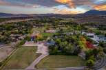 Experience luxury living in this sprawling estate, featuring meticulously maintained grounds with lush green fields and vibrant autumn foliage.