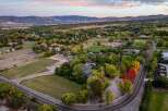 Discover this stunning property featuring expansive grounds perfect for equestrian activities, complete with white-fenced pastures and riding areas.