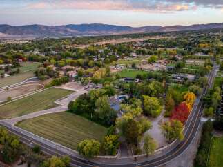 Discover this stunning property featuring expansive grounds perfect for equestrian activities, complete with white-fenced pastures and riding areas.