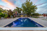 Experience luxury living with this stunning property featuring a sparkling swimming pool and expansive patio, perfect for entertaining.