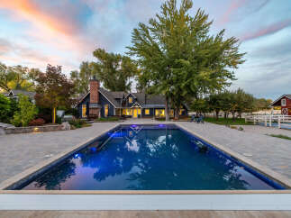 Experience luxury living with this stunning property featuring a sparkling swimming pool and expansive patio, perfect for entertaining.