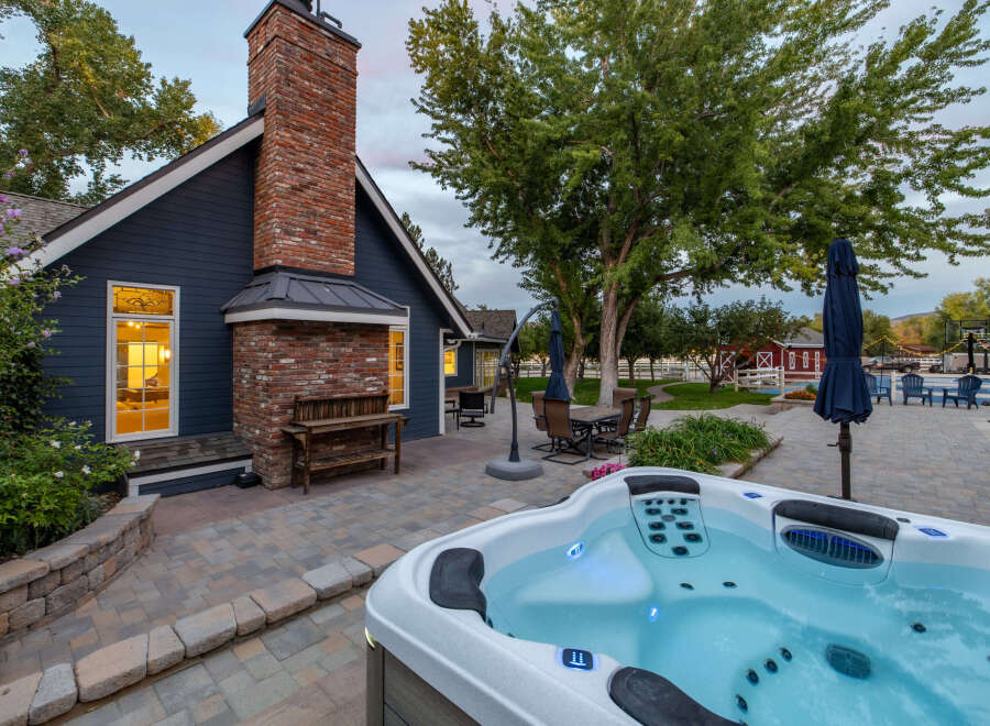 Experience ultimate relaxation in this stunning backyard oasis, featuring a luxurious hot tub perfect for unwinding.
