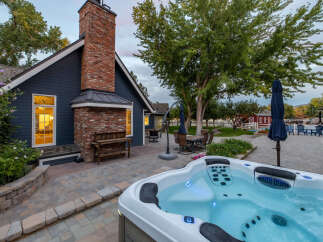 Experience ultimate relaxation in this stunning backyard oasis, featuring a luxurious hot tub perfect for unwinding.