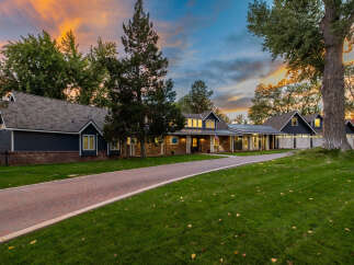 Experience luxury living in this stunning home featuring a long, winding brick driveway leading to a beautifully appointed facade.