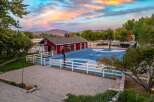 Experience the ultimate outdoor lifestyle with this stunning property featuring a regulation-size basketball court and a charming red barn.