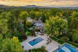 Experience luxury living with this stunning estate featuring a pristine swimming pool and a relaxing hot tub, perfect for unwinding.