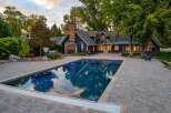 Experience luxury outdoor living with this stunning property featuring a sparkling swimming pool and expansive paver patio, perfect for entertaining.