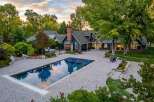 Experience luxury outdoor living with this stunning property featuring a pristine rectangular swimming pool and an adjacent hot tub, perfect for relaxation and entertainment.