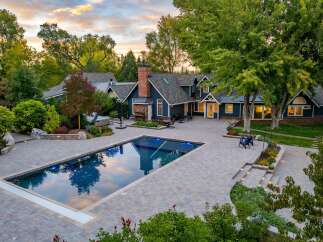 Experience luxury outdoor living with this stunning property featuring a pristine rectangular swimming pool and an adjacent hot tub, perfect for relaxation and entertainment.