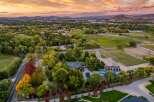 Experience luxury living in this expansive estate featuring a stunning residence, a vibrant blue swimming pool, and a full-size basketball court.