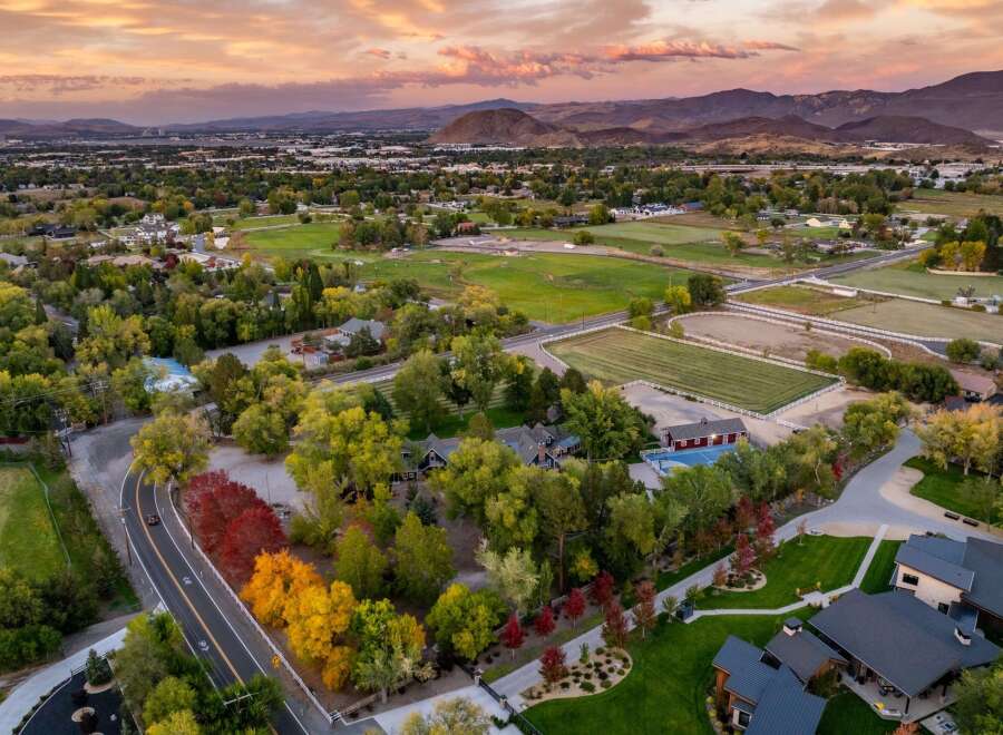 Experience luxury living in this stunning estate featuring a private basketball court and a vibrant equestrian facility, perfect for both recreation and training.