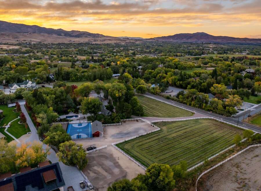 Experience luxury living with this stunning estate featuring a private basketball court and a sparkling swimming pool, perfect for recreation and relaxation.