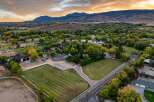 Discover this expansive property featuring meticulously maintained hay fields and riding arenas, perfect for equestrian enthusiasts.