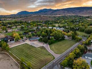 Discover this expansive property featuring meticulously maintained hay fields and riding arenas, perfect for equestrian enthusiasts.