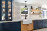 Discover a stunning kitchen featuring deep navy cabinetry paired with warm wood accents, creating a sophisticated and inviting atmosphere.