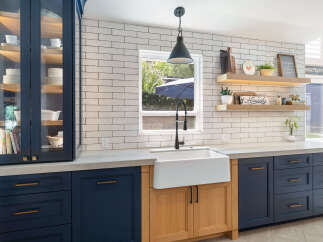 Discover a stunning kitchen featuring deep navy cabinetry paired with warm wood accents, creating a sophisticated and inviting atmosphere.
