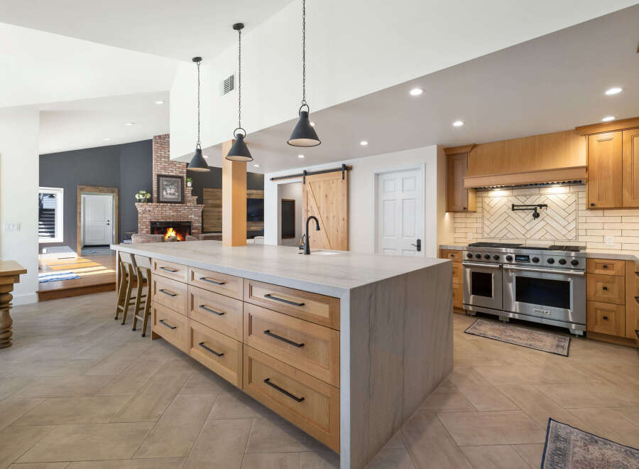 Experience luxury in this stunning kitchen featuring a large marble island with ample storage and seating.