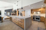 Experience luxury in this stunning kitchen featuring a large marble island with ample storage and seating.